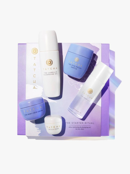 Tatcha The Starter Ritual Set white and purple skin care products on top of box on light gray background